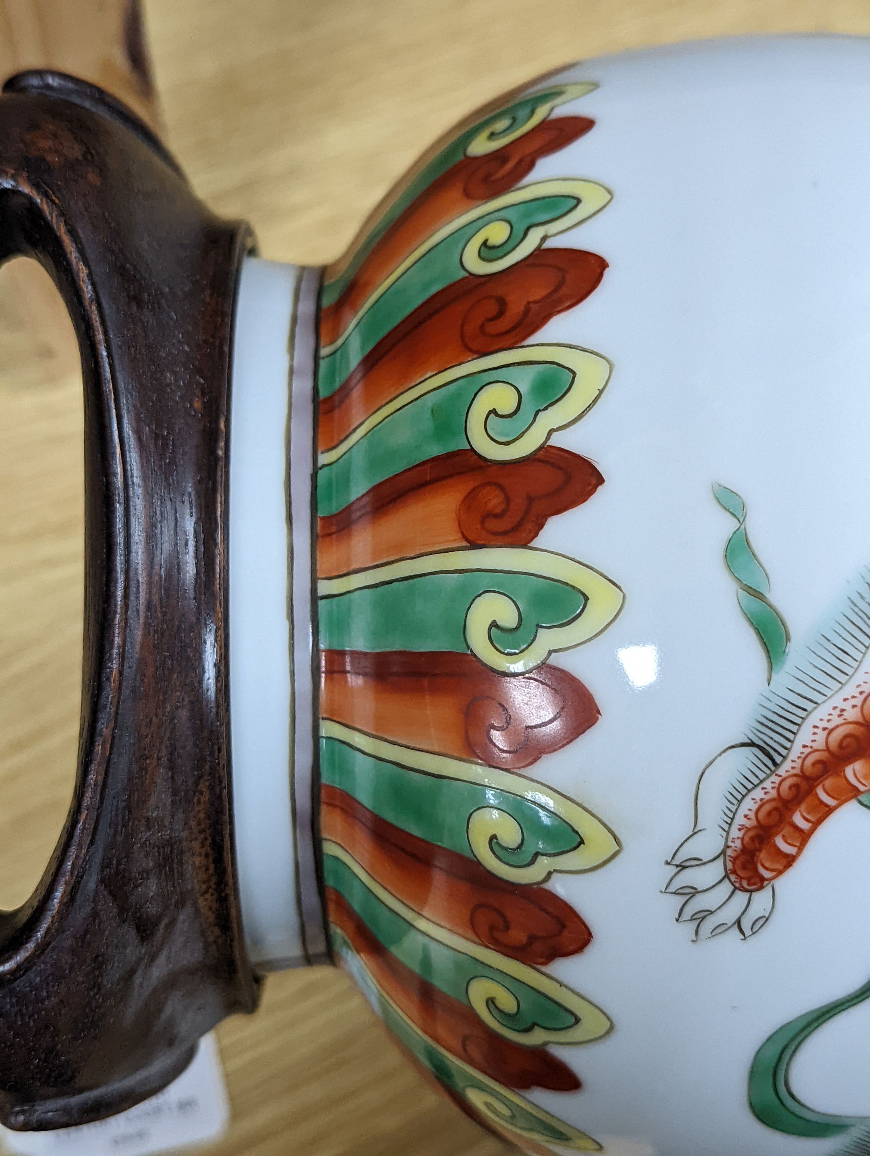 A Chinese famille verte pear shaped ‘Buddhist lion’ vase, on stand, 32 cms high not including stand.